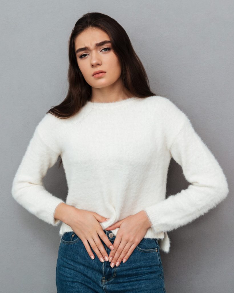 young-teenager-woman-with-stomachache-scaled.jpg